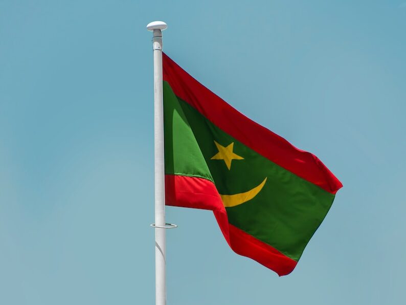 a red and blue flag on a flagpole